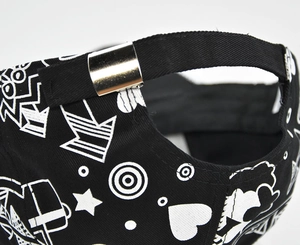Détail d'une casquette noire avec motifs graffiti blancs et boucle en métal argenté