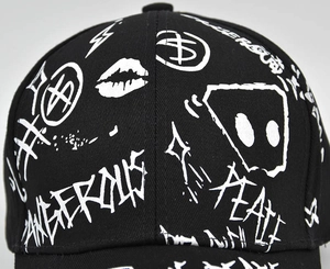 Detailed macro shot of street graffiti print on black cotton canvas baseball cap