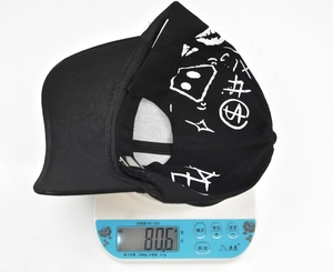 Close-up of lightweight black graffiti baseball cap weighing 80.6g on a digital scale