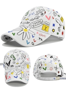 Detail view showing colorful graffiti print and metal buckle on white baseball cap