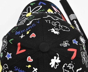 Detail of colorful graffiti prints and floral patterns on black cotton baseball cap