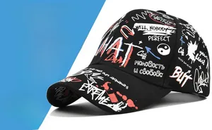 Detail view of black graffiti baseball cap with white and red urban street art patterns