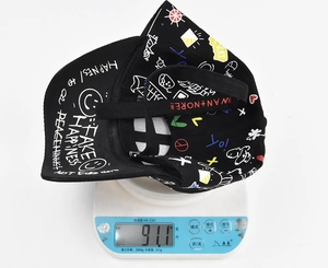 Graffiti printed baseball cap weighing 91.1g shown on an electronic digital scale