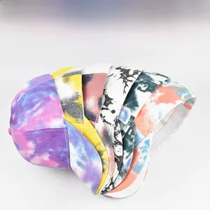 Close-up of assorted tie-dye ponytail baseball caps in multiple vibrant color patterns
