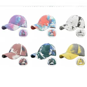 Detail view of six tie-dye ponytail baseball caps with criss-cross elastic back design