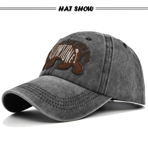 Close-up of the vintage grey washed baseball cap featuring a Yellowstone bear embroidery patch