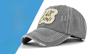 Detail of the washed grey baseball cap featuring the I do Crew embroidery and contrast stitching