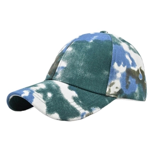Macro view of tie-dye baseball cap fabric with blue and green camouflage pattern