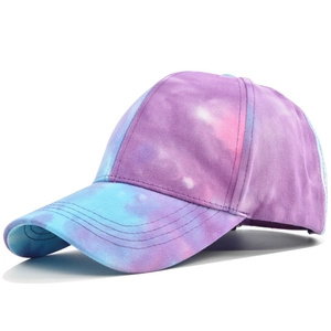 Detail view of tie-dye baseball cap with purple, pink and light blue gradient stitching