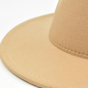 Close-up of the fine stitching and texture on the brim of a khaki wide-brim felt fedora hat