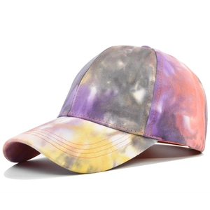 Detail of multi-color tie-dye baseball cap with reinforced stitching and cotton texture