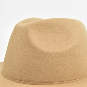 Detail of wool felt fedora showing crown indentation and stitching on the camel wide brim