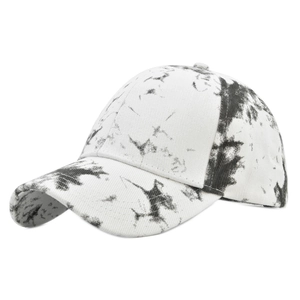 Detail view of tie-dye baseball cap with black splatter pattern and curved brim