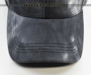 Detail view of tie-dye baseball cap brim with durable stitching and washed canvas texture