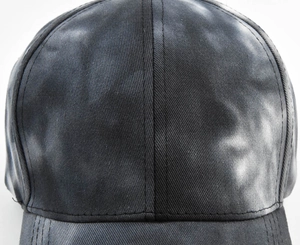 Macro shot of black-grey tie-dye baseball cap fabric texture and fine stitching detail