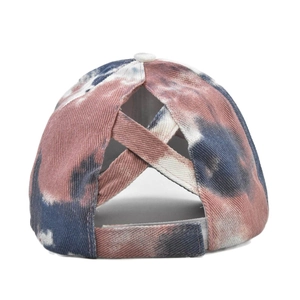Detail of tie-dye ponytail baseball cap featuring criss-cross elastic bands and velcro strap