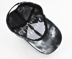 Detail view of tie-dye baseball cap interior with adjustable silver buckle and inner lining