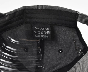 Internal detail of a washed dark grey cotton baseball cap showing the black sweatband and label