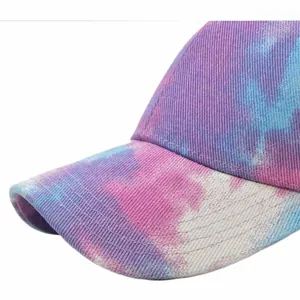 Detailed close-up showing tie-dye pattern and twill fabric texture of the baseball cap
