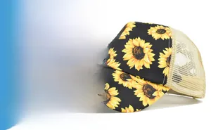 Detail view of sunflower print cotton ponytail hat with breathable mesh back and curved brim