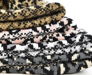 Close-up of thick knit winter hats with leopard patterns in various stylish colorways