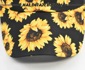 Close-up of sunflower print detail on black cotton twill baseball cap fabric