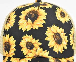 Detailed close-up of sunflower print on black twill fabric and breathable mesh of baseball cap