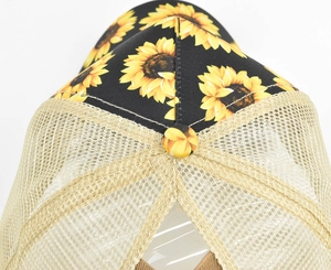 Top-down view of the sunflower print panel and breathable mesh back on the baseball cap