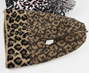 Detail view of the 100% acrylic material label and leopard knit texture on winter hat