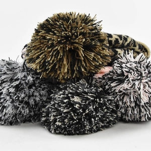 Winter leopard print knit beanie with assorted fluffy pom-poms for cold weather warmth