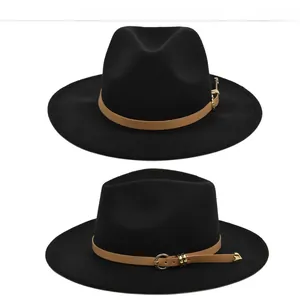 Detail of vintage wool fedora hat with brown leather band and gold metal buckle trim