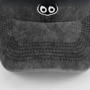 Close-up of Route 66 white embroidery and reinforced stitching on washed charcoal cotton cap