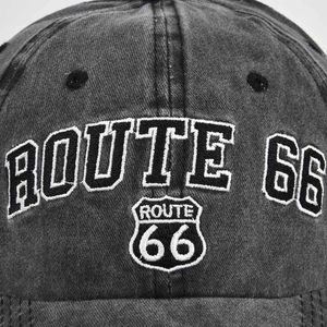 Close-up of Route 66 shield embroidery and breathable eyelets on washed denim baseball cap