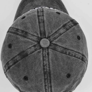 Top view detail of washed dark gray baseball cap showing embroidery and six-panel stitching