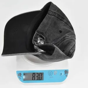 Close-up of lightweight washed cotton denim baseball cap weighing 83g on a scale