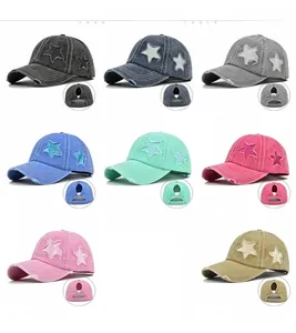 Multiple colors of distressed ponytail baseball caps with star patch and ripped details