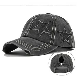 Close-up of distressed baseball cap with star patch and ponytail hole detail