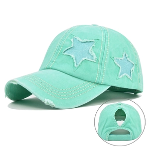 Detail of mint green distressed ponytail baseball cap with glitter star and bun opening