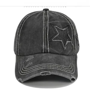 Close-up of distressed washed cotton baseball cap with vintage star patches and frayed details