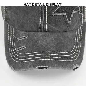 Distressed dark gray ponytail baseball cap with glittery star patch and white stitching