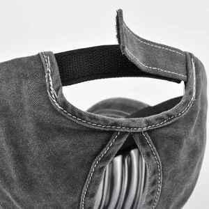 Detail view of washed grey canvas ponytail cap featuring adjustable velcro strap closure