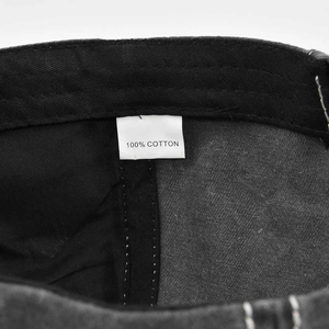 Macro detail of the 100% cotton wash label and twill fabric on this washed ponytail cap