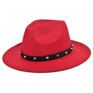 Detail of red wool fedora hat with black leather band featuring silver punk metal studs