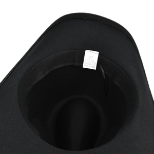 Detail of black fedora hat interior showing size 57 label and 65 percent polyester blend