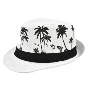 Detailed view of white straw fedora with black coconut tree patterns and a wide ribbon