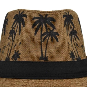 Detail of woven straw fedora hat featuring black coconut tree print and grosgrain ribbon