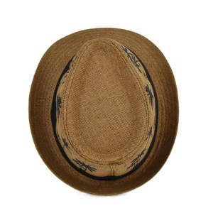 Close-up of brown straw fedora hat featuring a black tropical palm tree print ribbon band