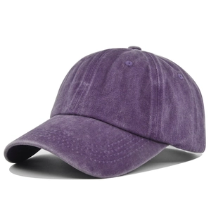 Close-up of vintage washed purple cotton baseball cap fabric texture and stitching details