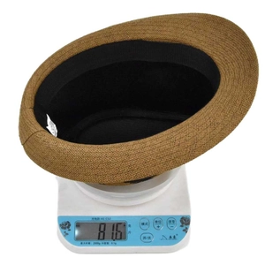 Detailed shot showing the lightweight 81.6g weight of this brown straw jazz fedora hat