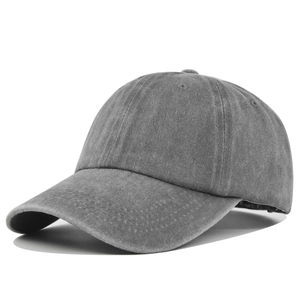 Macro detail of high-quality grey washed cotton fabric and curved brim of the baseball cap